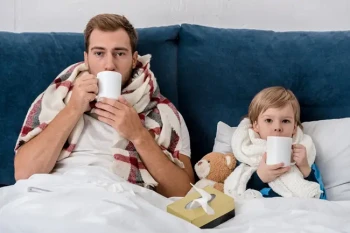 Father and son enjoying tea when sick