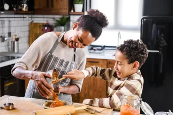 Family cooking while keeping eyes safe