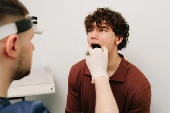 Patient receiving an examination for mouth ulcers and oral ulcers